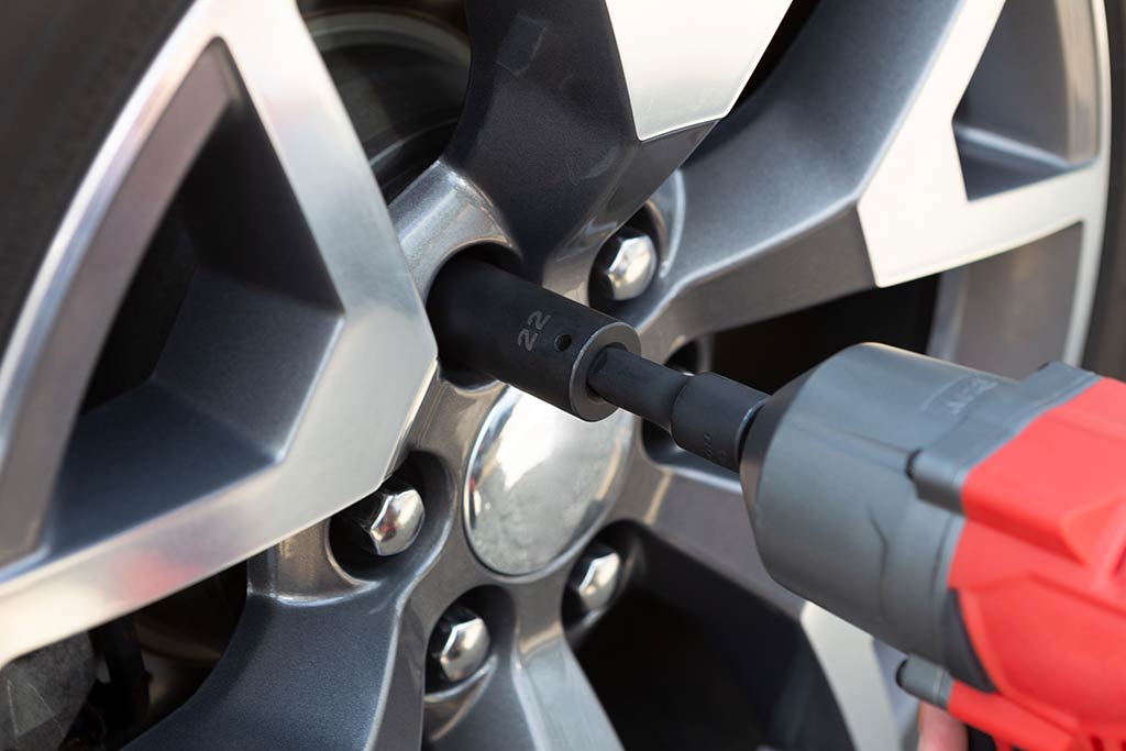 A worker is fixing car wheel problem