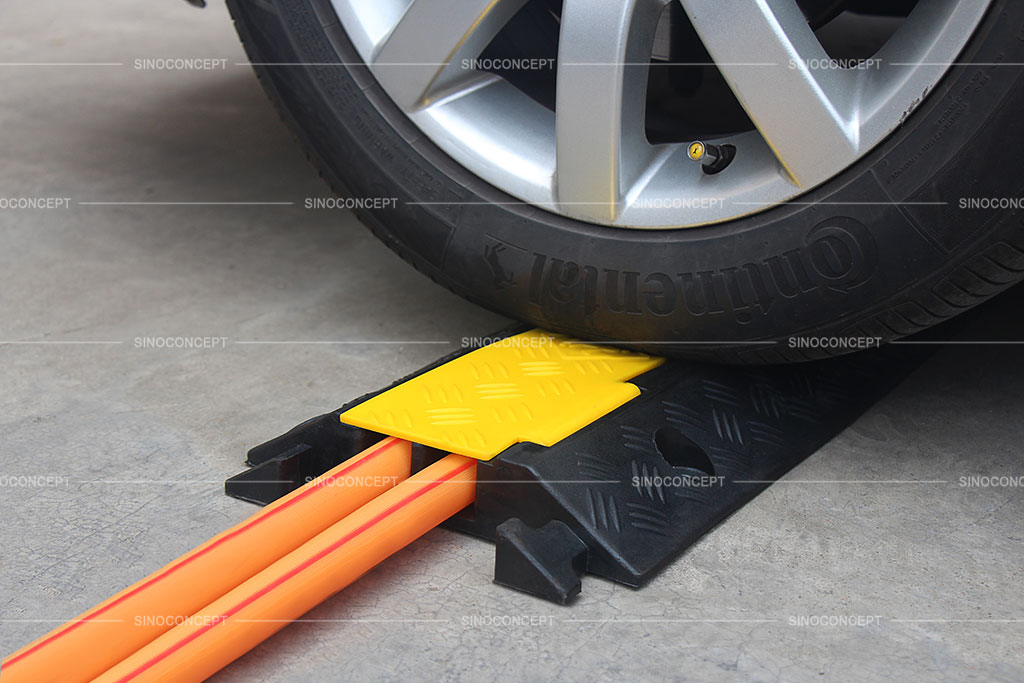 Rubber cable protectors with a yellow lid to cover hoses