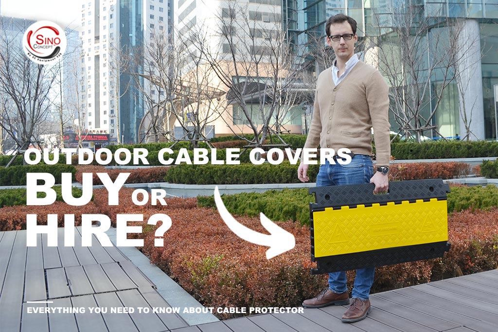 A man is carrying a rubber cable protector that has a convenient handle