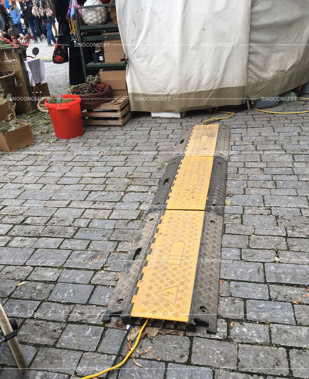 Used cable protectors with yellow covers to protect cables on the street