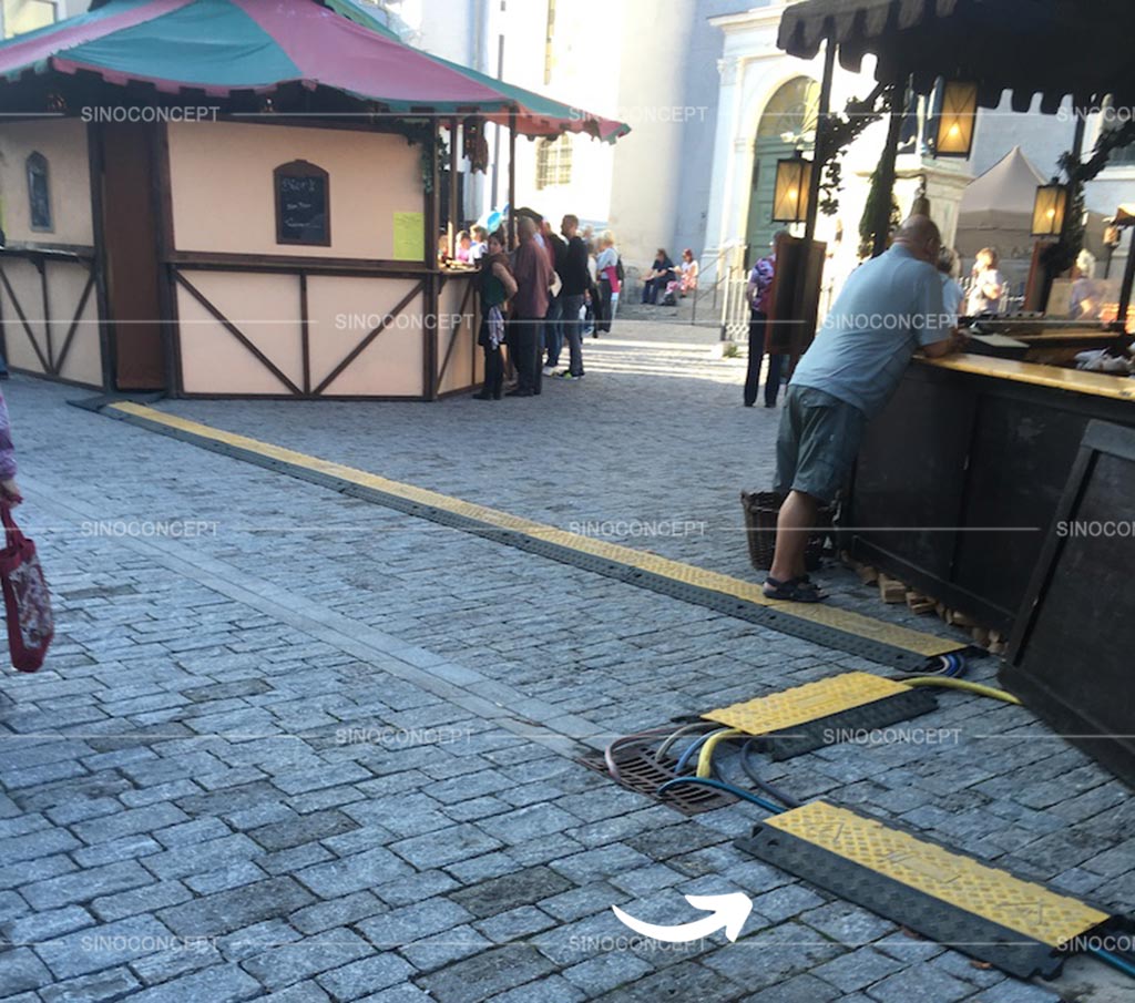 Multiple cable ramps are connected together across the street to cover cables