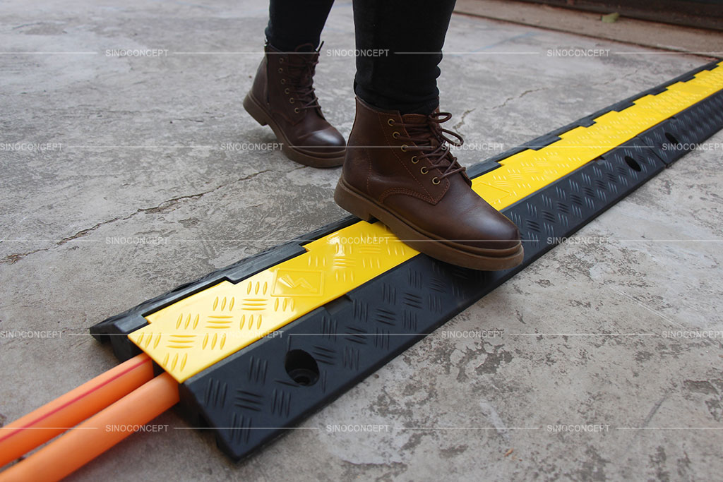 Rubber cable protectors used to protect hoses from pedestrians or vehicles