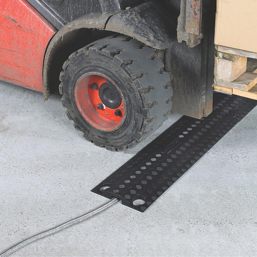 Low profile drop over cable ramp coloured in black to protect cables from vehicles