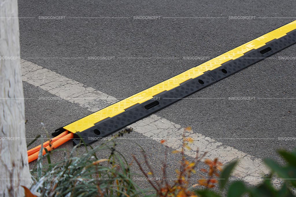 Multiple cable protectors connected together across the street to cover hoses or cables