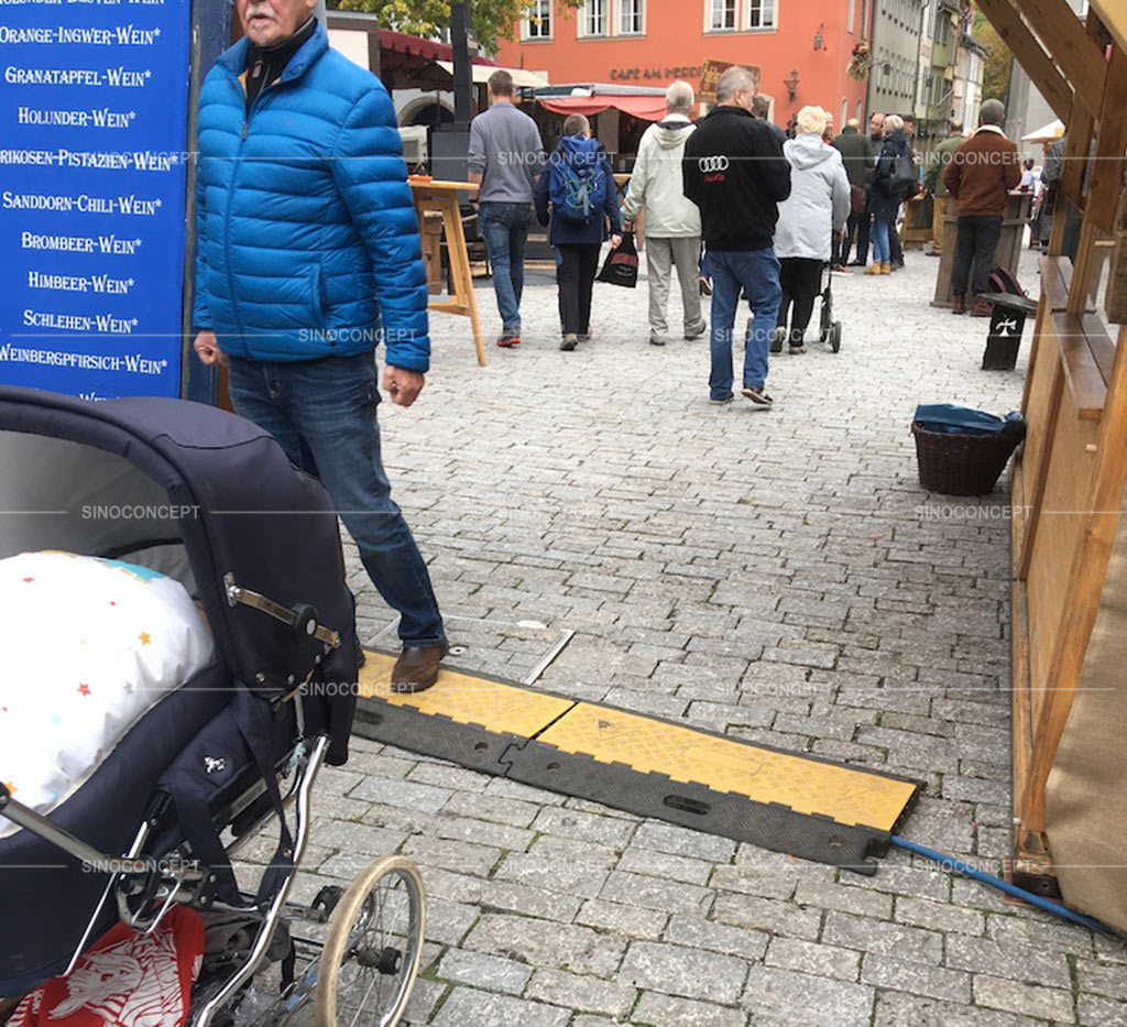 A used rubber cable ramp was put on the street to protect cables