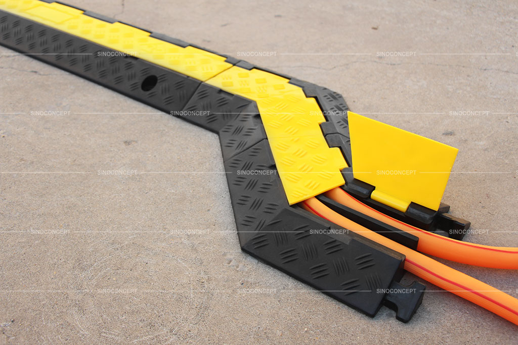 Black and yellow cable protectors connected together with some angle parts to protect hoses