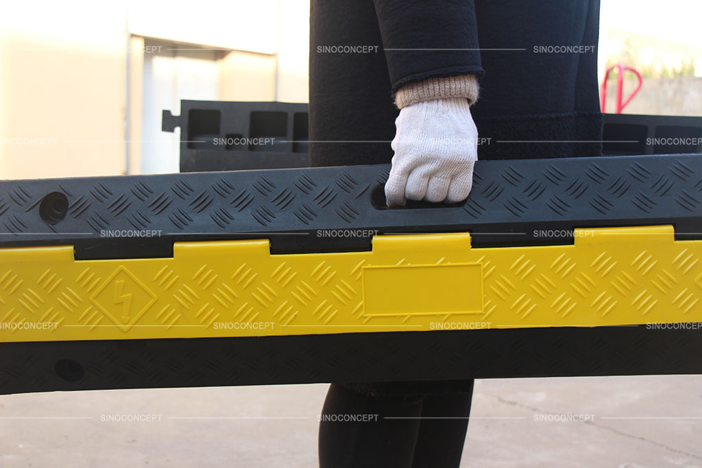 Rubber cable ramps designed with convenient handles to carry