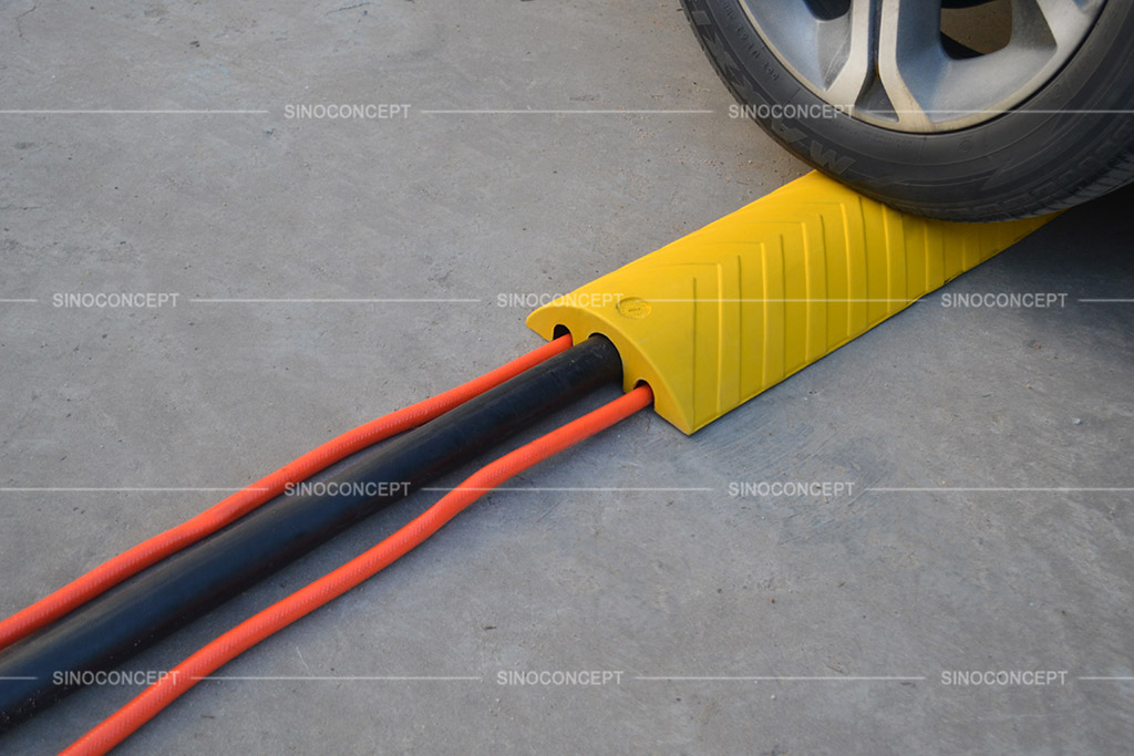 Yellow floor cable cover to protect hoses or cables