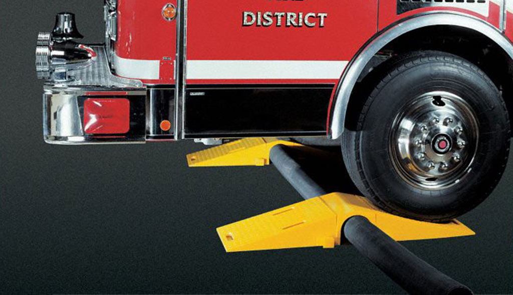 Yellow hose bridges to protect hoses from heavy vehicles