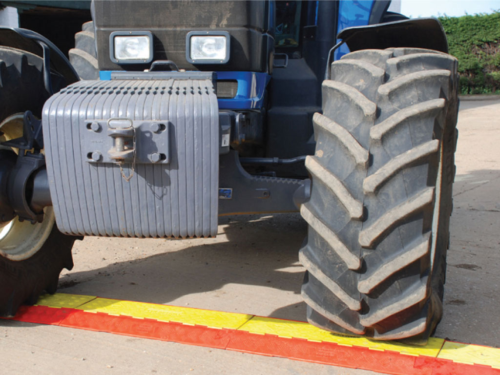 Orange and yellow cable ramps used to bear heavy vehicle