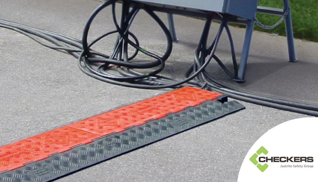 Black cable ramp with red lids to protect cables manufactured by Checkers.