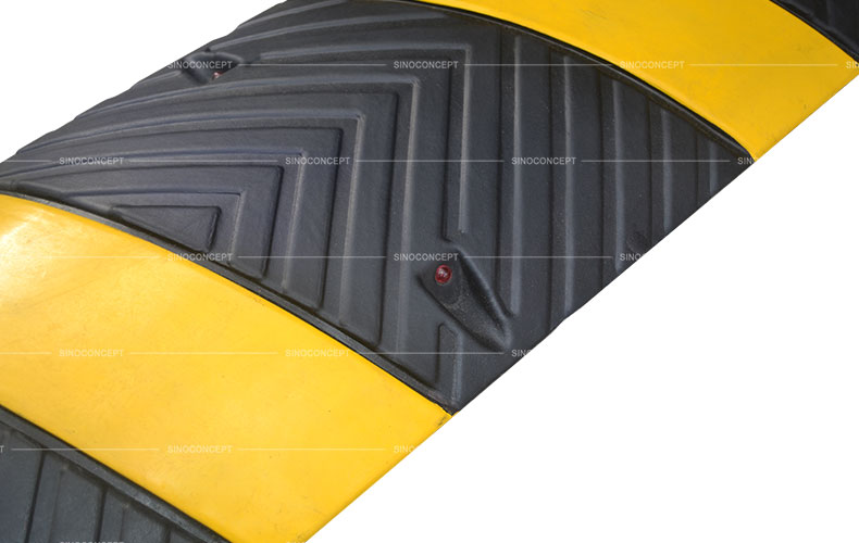 1830 mm speed bump made of black and yellow recycled rubber with anti-slip arrows design and embedded cat-eye reflectors