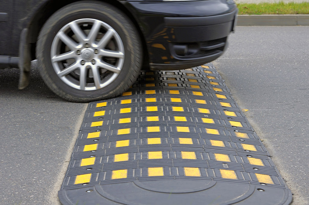 Black speed hump made of rubber with yellow reflective films for traffic calming purposes