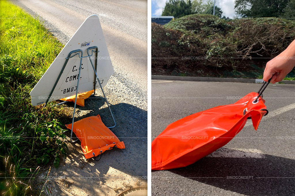Orange sandbags made of PVC material are used to hold down traffic signs