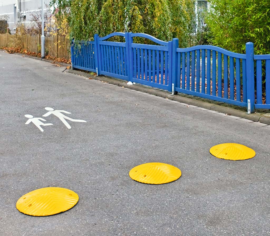 Small round speed bumps coloured in yellow, installed on roads to ensure traffic safety