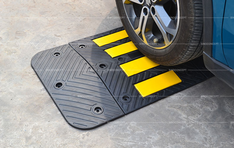 Rubber road hump made of black vulcanized rubber with anti-slip arrows design and yellow reflective tapes for traffic calming