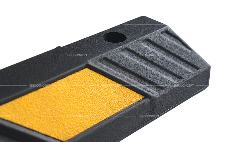 Rubber parking wheel stop surface with black rubber arrows and yellow reflective tapes for garage or commercial parking
