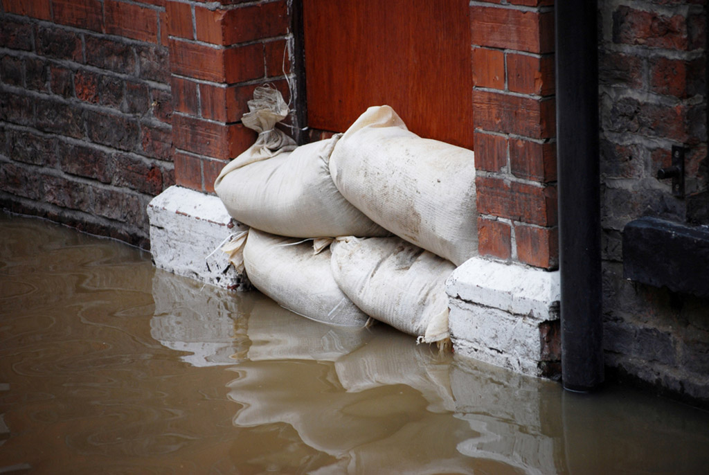 White sandbags are put in front of the door to prevent flooding
