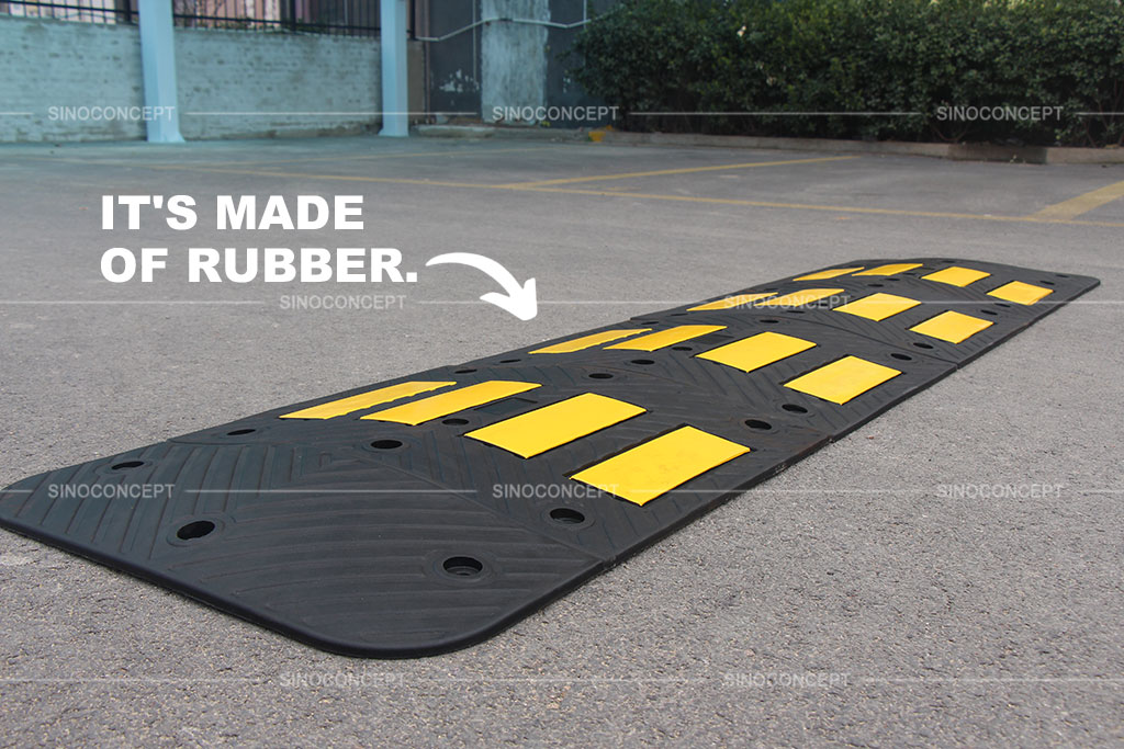 Speed hump made of vulcanized rubber coloured in black and with yellow reflective strips