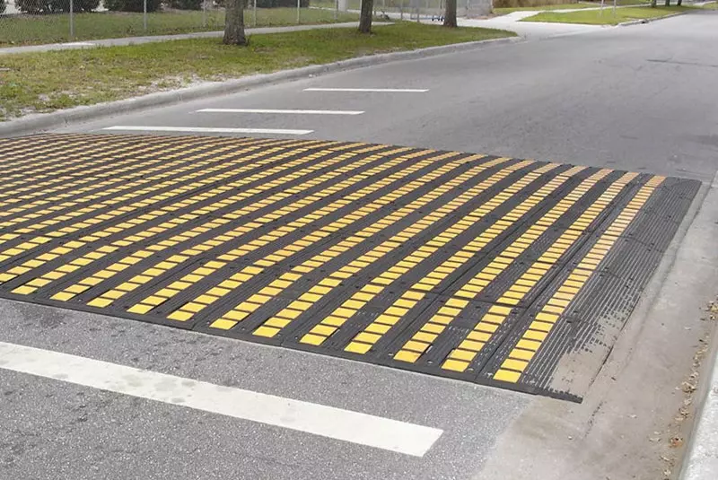A yellow and black speed table is placed on the ground