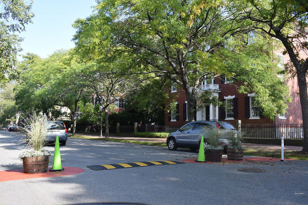 A traffic calming hump installed at an outdoor parking space for better traffic management