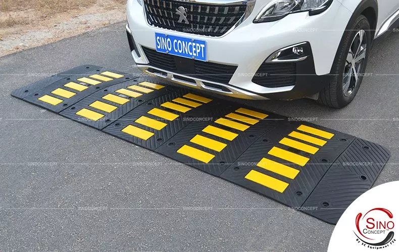Rubber speed hump made of black vulcanized rubber with anti-slip arrows design and yellow reflective tapes for traffic calming