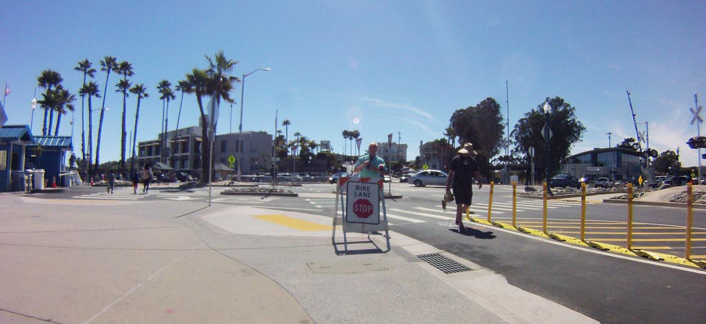 Yellow lane separator curbs with yellow posts inserted on the base to divide a safe bike lane for bike riders