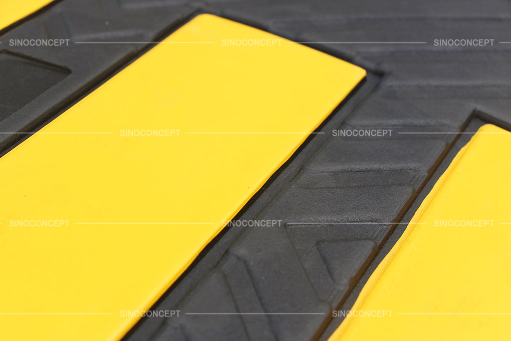 Yellow reflective films pasted on the black speed hump to be highly visible to the drivers