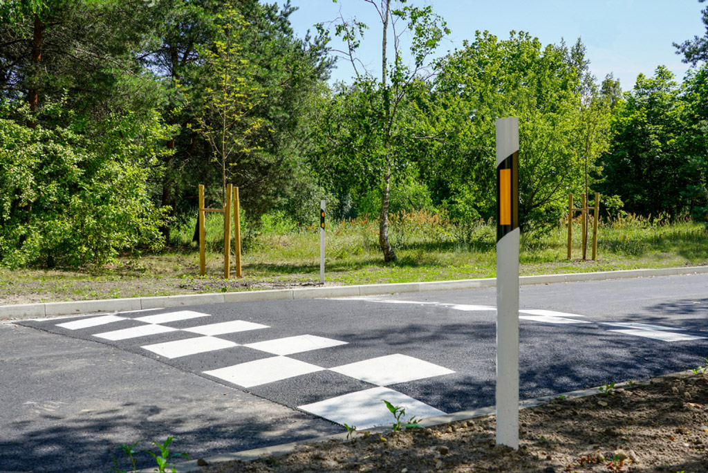 Black and white speed bump made of asphalt set on the road to calm traffic