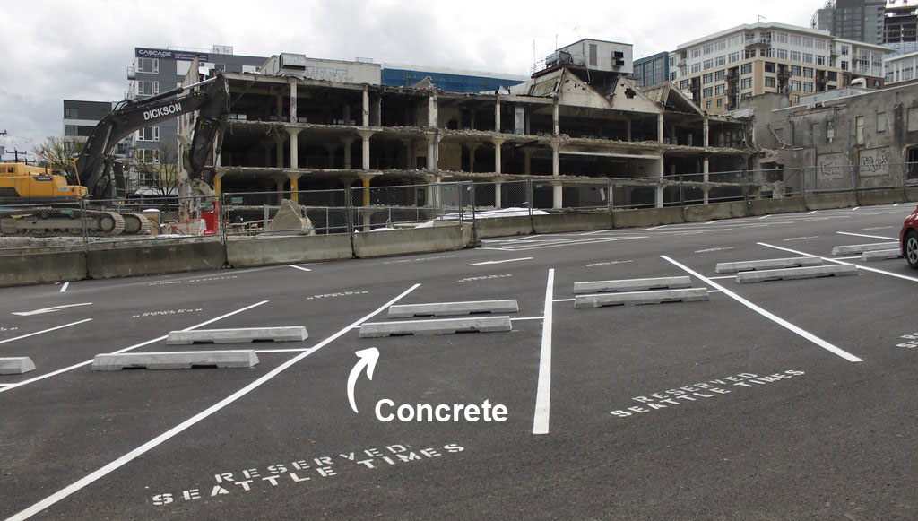 White concrete car stops set on an outside parking lot for better parking management