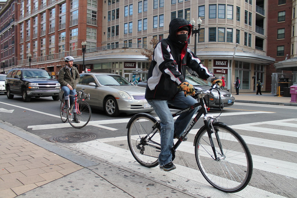 Cyclists are riding in their cycle lanes which are marked by white paintings to distinguish them from motor vehicle lanes