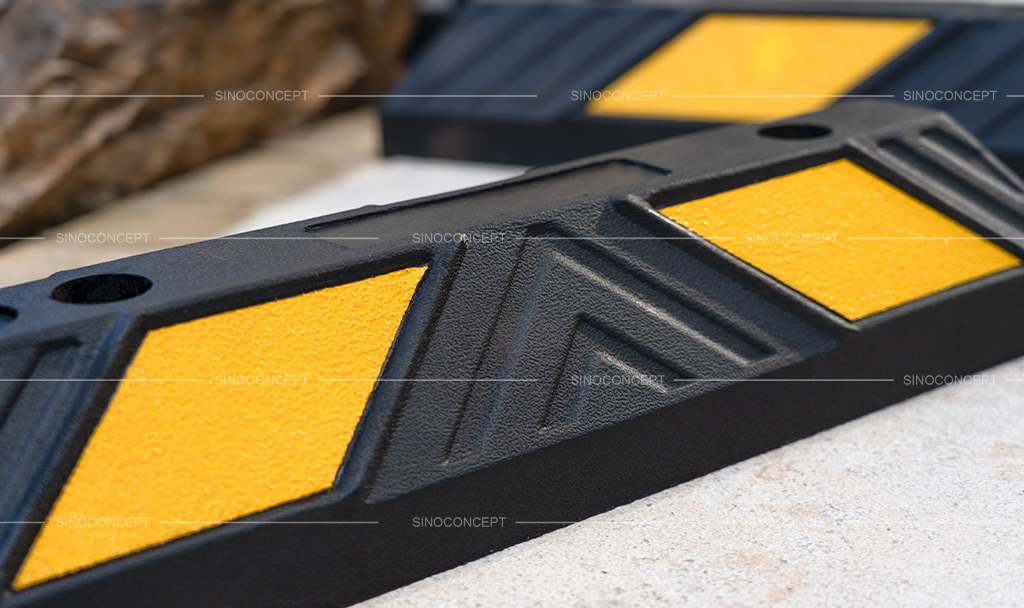 Rubber parking blocks made of black recycled rubber with yellow glass bead reflective tapes for car park management.