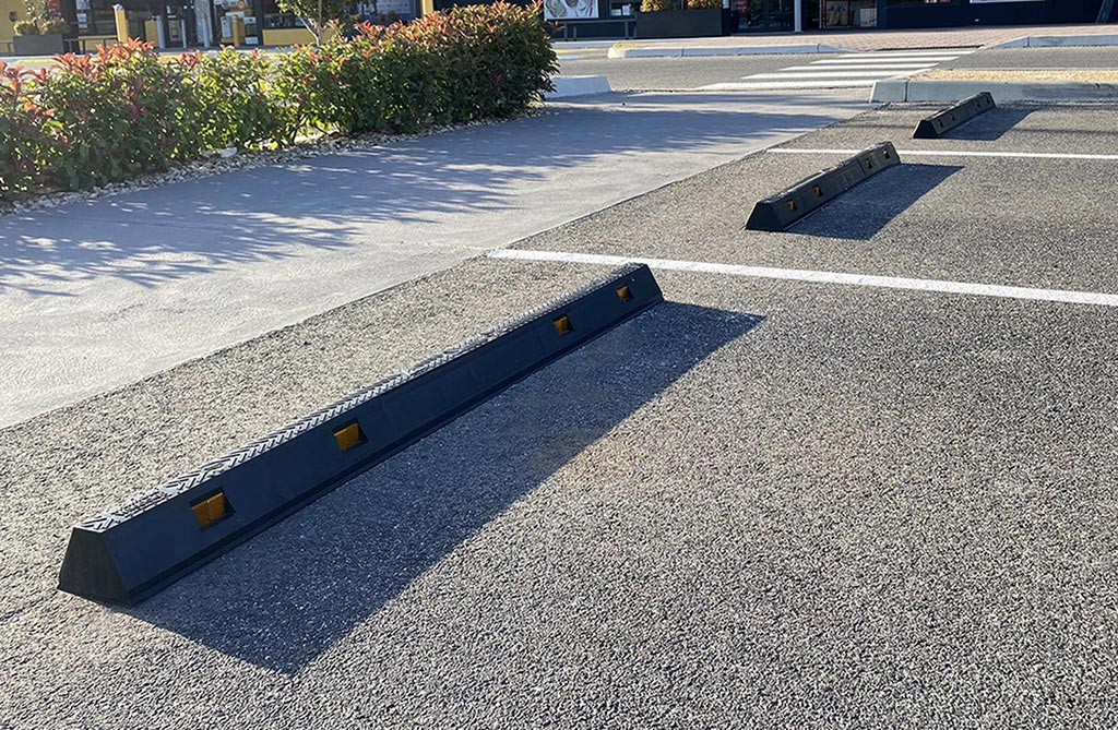 Several black parking kerbs installed in the outside parking lot