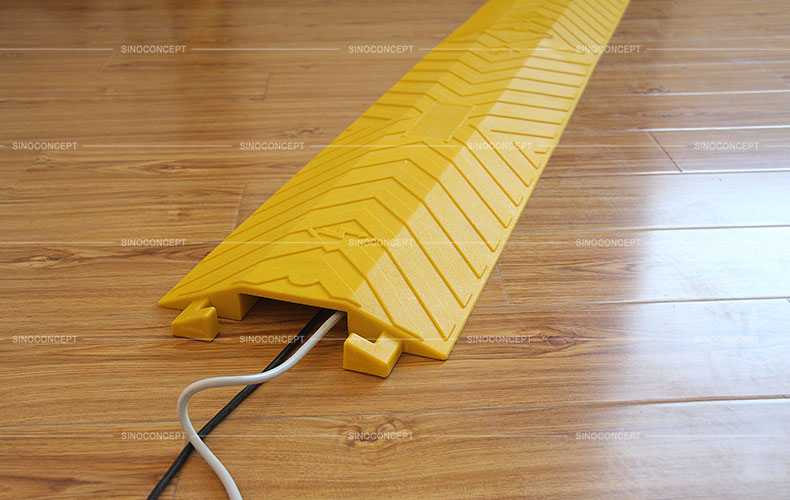 Large yellow drop over cable ramp made of polyurethane with one channel to protect cables, designed with anti-slip surface