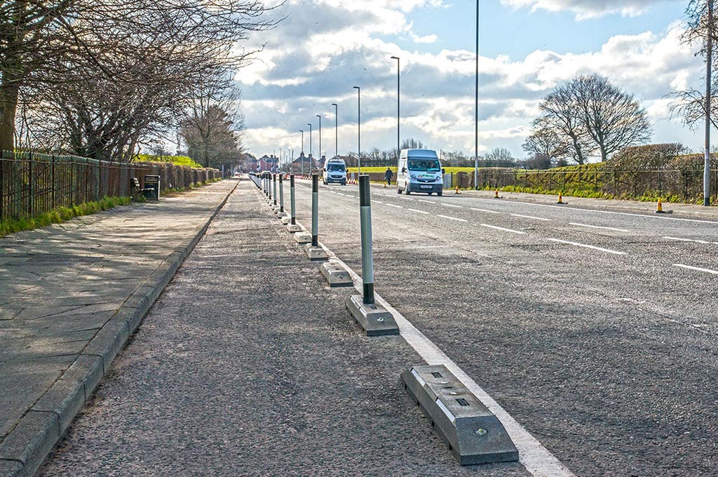 Black Rosehill cycle lane defenders with posts inserted in the middle to separate a lane for cyclists