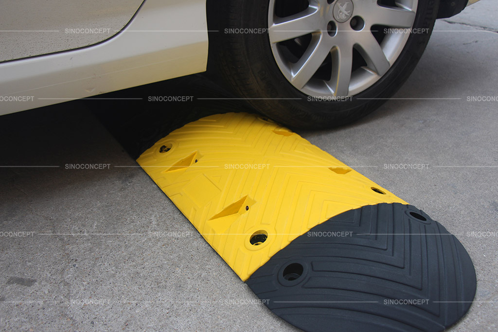 Rubber speed ramp coloured in yellow and black for calming traffic