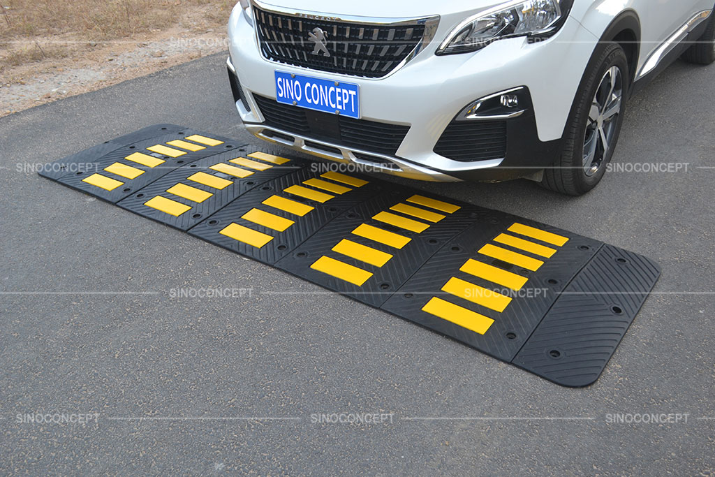 Black and yellow speed humps made of vulcanized rubber used on roads for traffic management