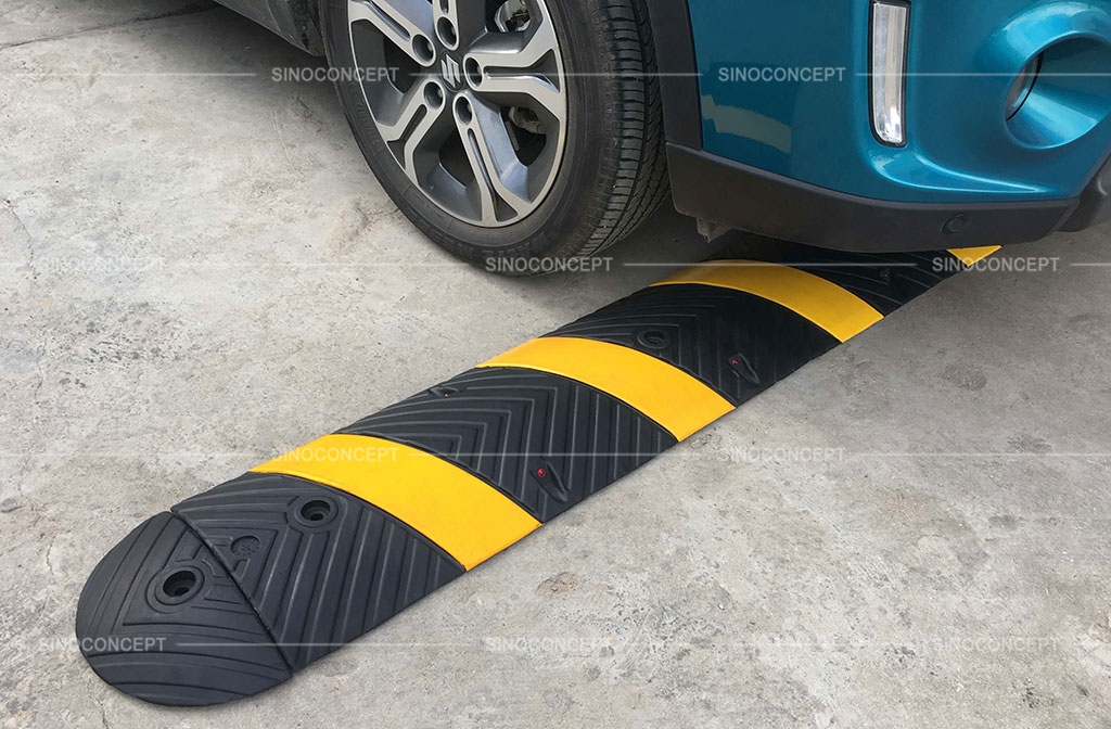 Black and yellow speed ramp designed with anti-slip surface and embedded with reflective road studs