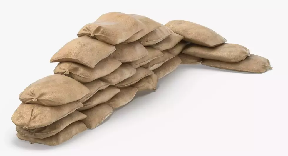 Many sandbags are stacked together to make a sandbag barricade