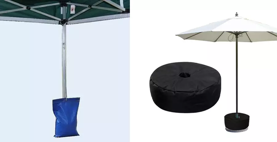 A blue sandbag and a black sandbag is used to hold an umbrella to prevent them from falling down.
