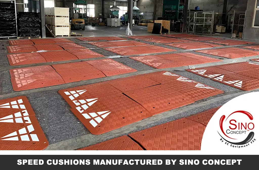 Many Europe-style red road speed cushions made of rubber are on the ground at Sino Concept's factory.