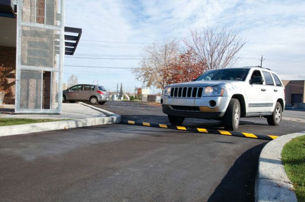 Black and yellow speed breaker installed on the entrance to reduce vehicle speed