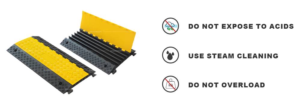 Black rubber cable ramps with high-visibility yellow lids for cable management.