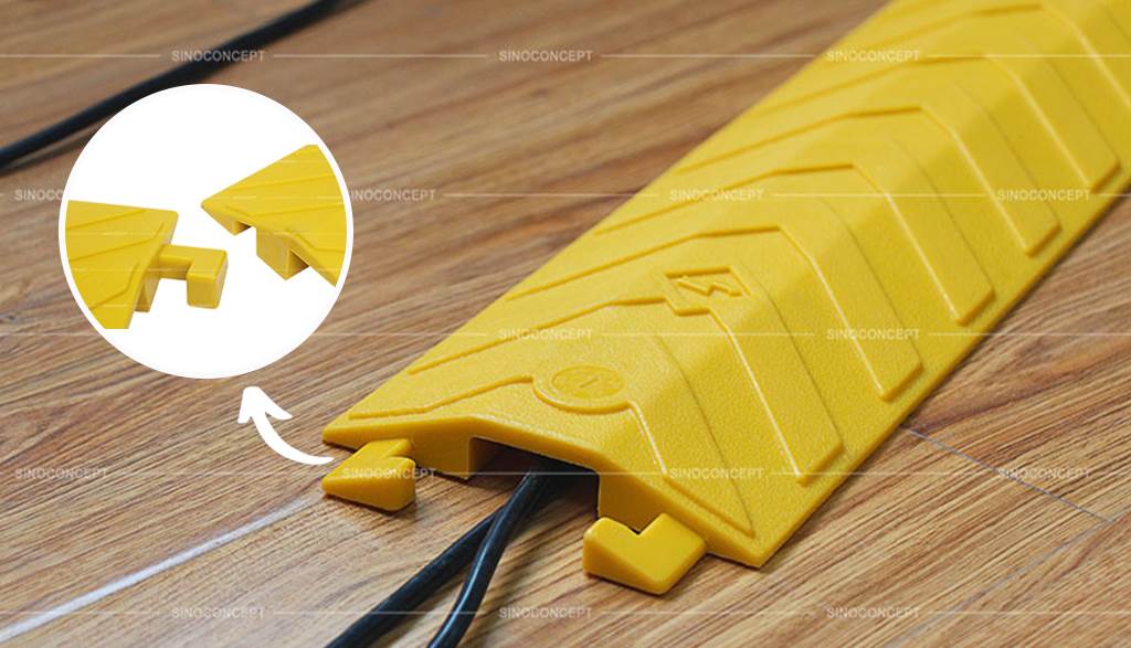 A yellow drop-over cable protector hides and protects wires for electronic devices and other cables to avoid potentially hazardous.