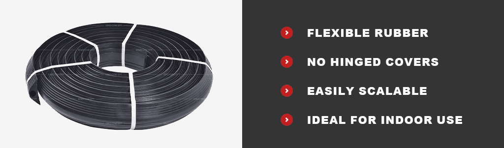 Black floor cable cover made of recycled rubber to protect cables and wires.