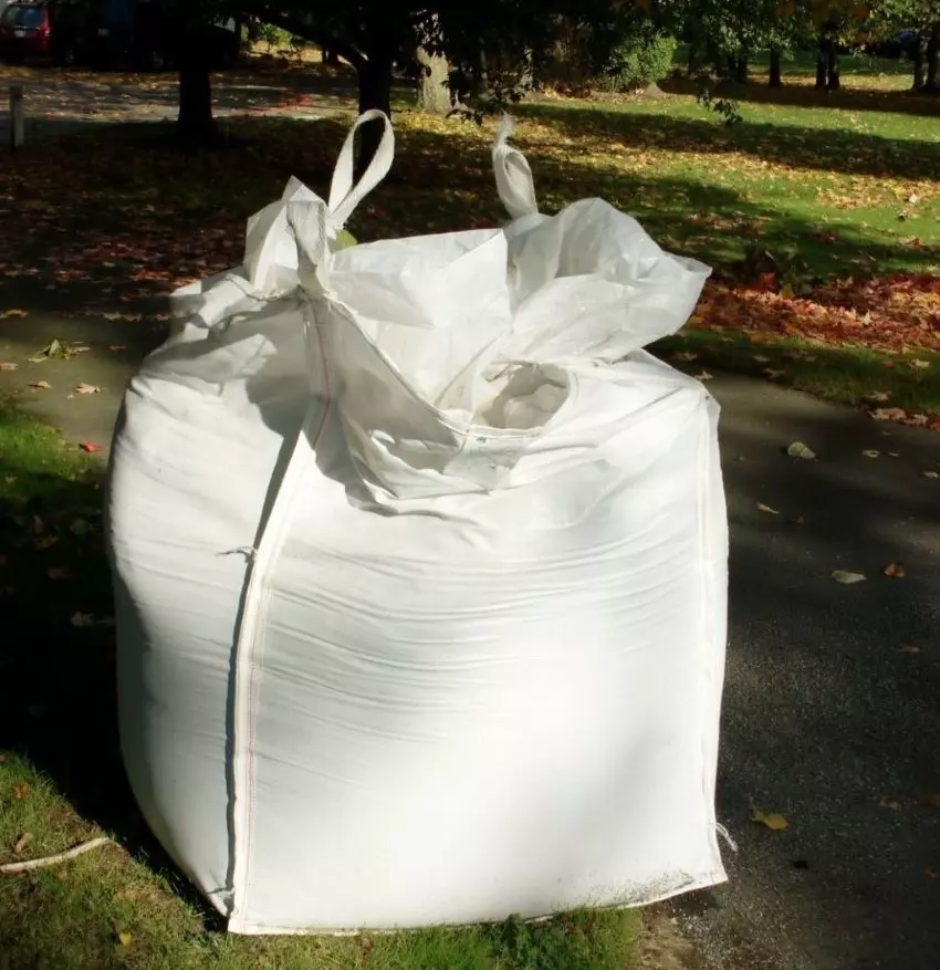 A white heavy-duty sandbag made from tough woven polypropylene.