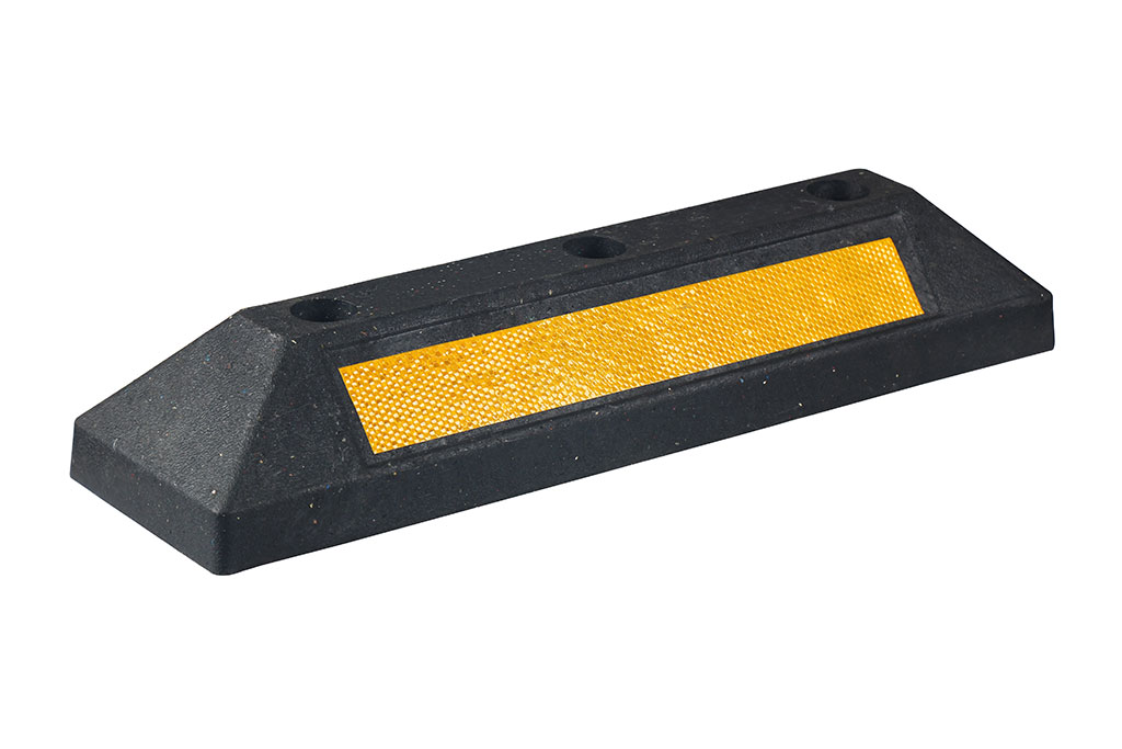 Black parking kerb pasted with yellow reflective tapes for high visibility