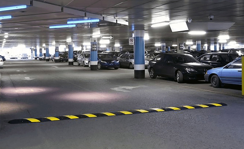 A long road bump installed in the parking lot for traffic safety purpose