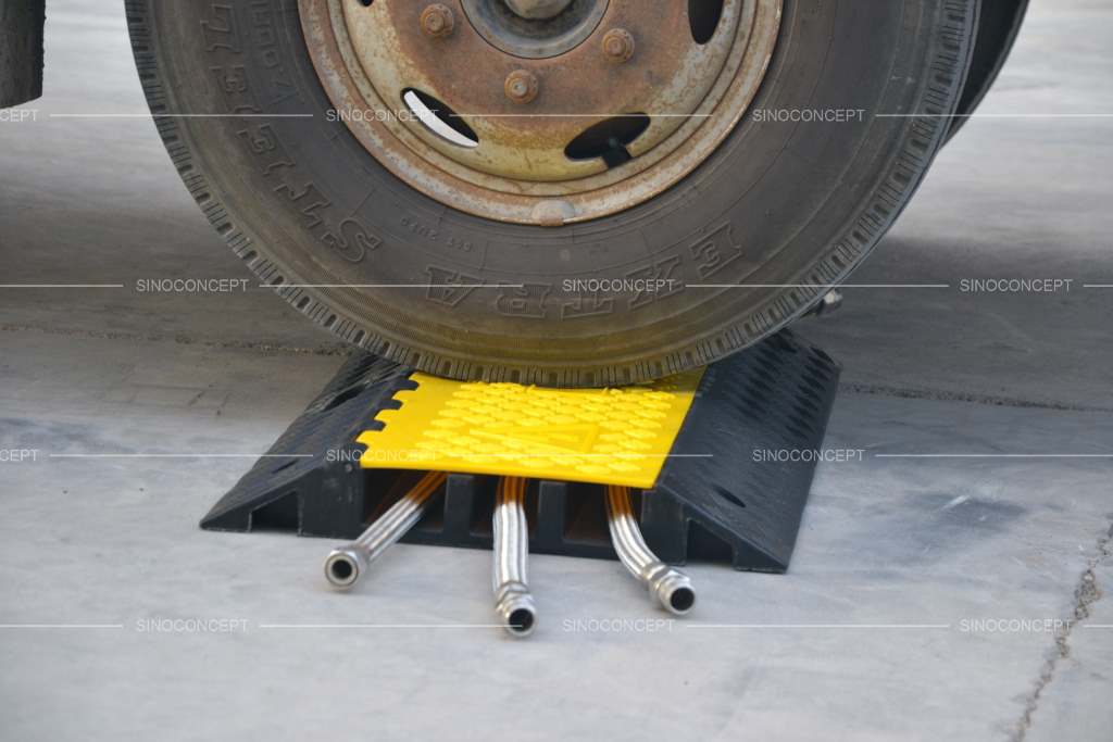 Rubber heavy-duty cable ramp on the ground to protect the cables from the heavy wheels of trucks.