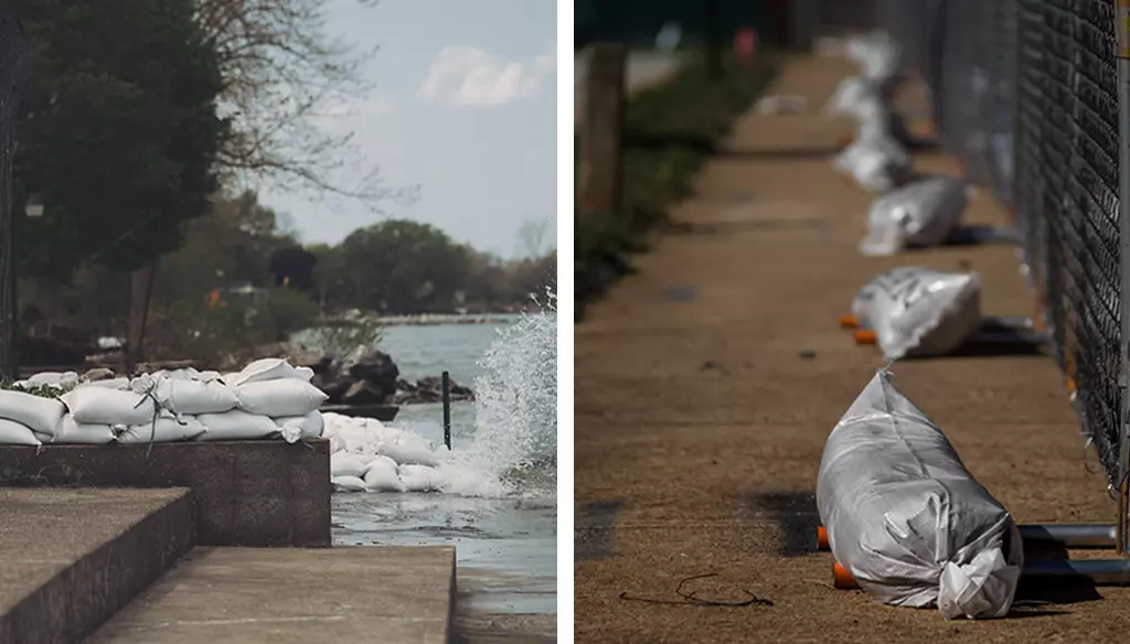 Many white sandbags stacked together to prevent flooding, and some white sandbags are holding black wire mesh to prevent falling down.